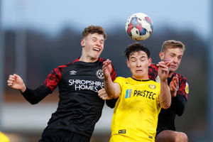 Rob Street and Killian Phillips of Shrewsbury Town challenge Terry Taylor of Burton Albion..