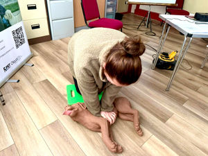 Practicing CPR on a manikin dog, one of the vital skills owners can learn at the first aid event.