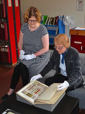 Jo Smith, registrar, pores over a Victorian tile catalogue