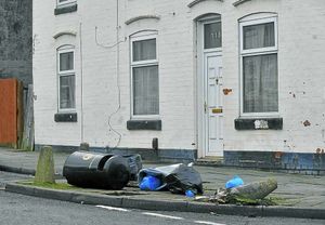 Discarded rubbish spills on to the street