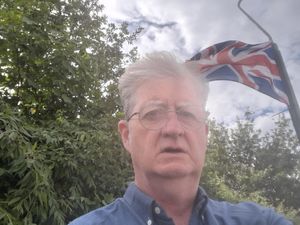 Councillor Julian Dean in front of a Union Jack flag. He described the raising of flags on lamp posts in Shrewsbury as part of an "intimidatory campaign".