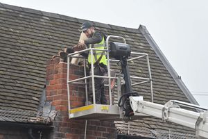 A workman  lowering the chimney 
