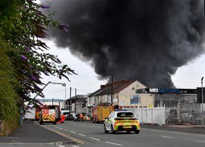 Black smoke pours into the sky from the fire at GB Tyres in West Bromwich. Photo: Tim Thursfield