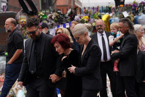 The family of Ozzy Osbourne (left to right) Jack, Sharon and Kelly Osbourne, view the messages and floral tributes left at the Black Sabbath Bridge bench on Broad Street in Birmingham in memory of Black Sabbath frontman Ozzy Osbourne, as his body is brought back to his home city for a procession following his death last week aged 76. Picture date: Wednesday July 30, 2025. PA Photo. Photo credit should read: Joe Giddens/PA Wire