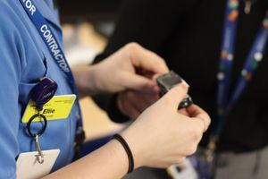 An NHS nurse checks a staff members pulse during a special event at Perryfields Academy