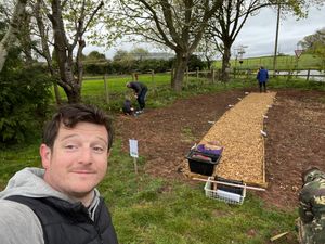 Cllr Neil Bentley getting ready to fix some of the broken fencing.
