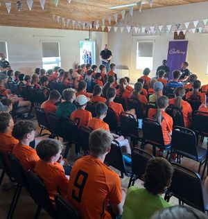 Spending time with players aged 12 and over learning about the drive, determination and resilience it takes to excel in football.