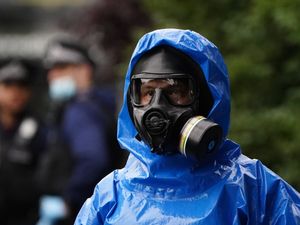 Supporting image for story: Police in bio-hazard gear raid property in drug-supply investigation