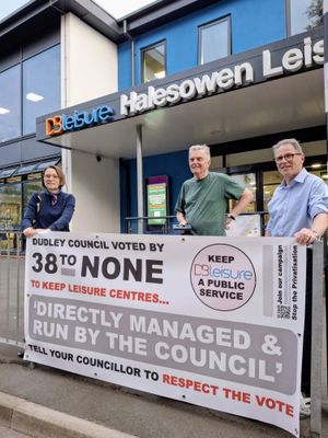 Campaigners celebrate victory -- with a banner that they never needed to use!