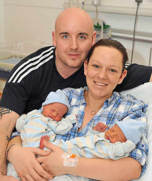 Newborns Max and Tom with their parents in 2011