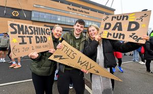 Lucy, James and Amber Pearce with signs for their dad