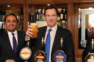 Chancellor George Osborne with a pint of Sunbeam ale alongside Conservative MP for Wolverhampton south west Paul Uppal (left) during a visit to Marston's Brewery in Wolverhampton.