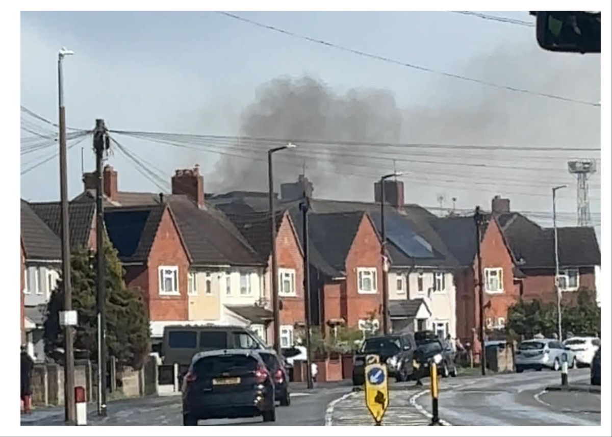 Fire crews rush to blaze in Wednesbury as fire engulfs garden fence sending grey and black smoke billowing into sky