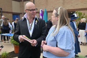 Harry Hill signs a book for Sophie Taylor during the event.