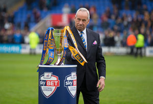 Shrewsbury Town chairman Roland Wycherley and the Sky Bet football league runners up trophy. (AMA)
