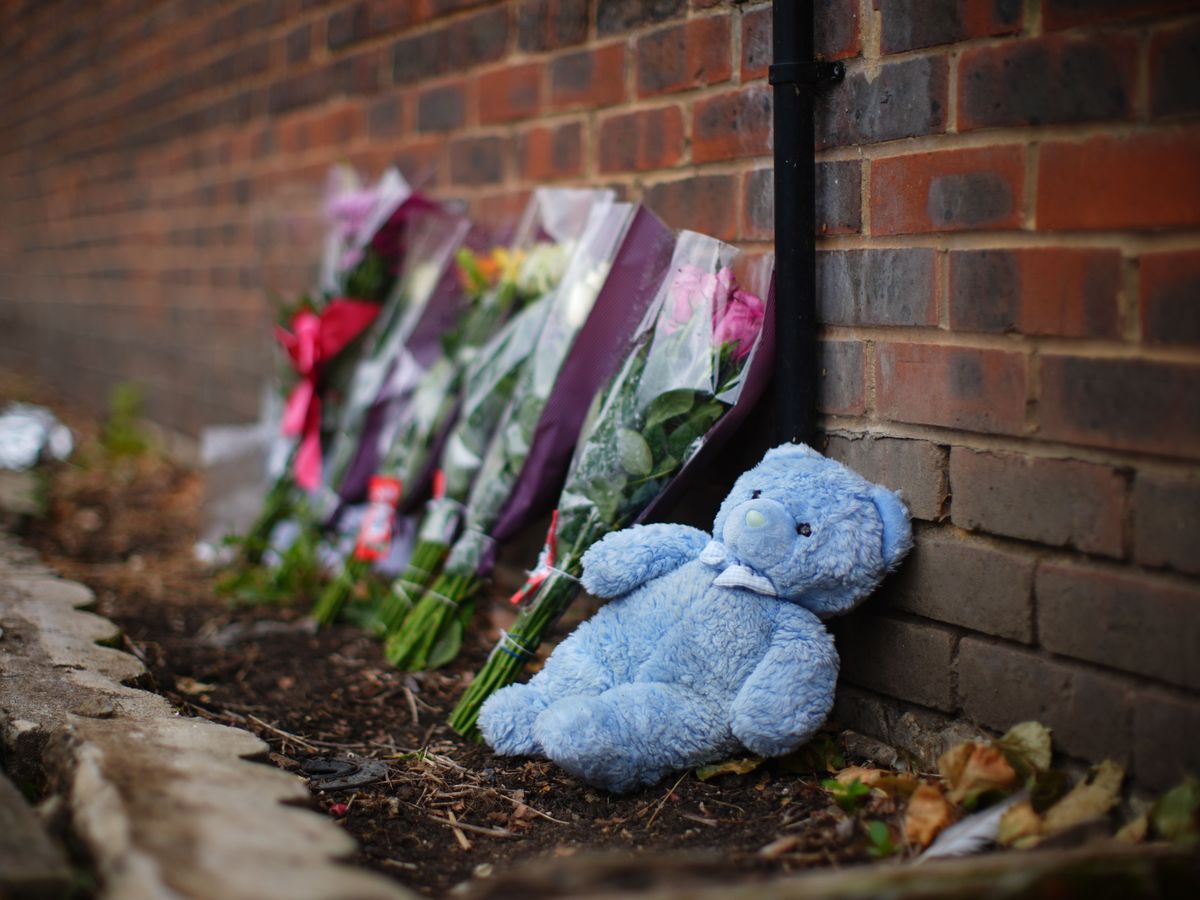 Floral tributes left at scene of house fire where mother and three children died