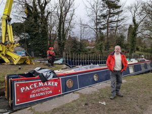 Paul Stowe with his boat, Pacemaker, as it was being refloated