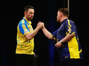 Luke Humphries, left, and Luke Littler shake hands