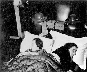 Stocking at the end of the bed, along with steel helmets... Sylvia and mum Daisy at Christmas 1940.