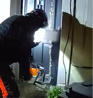 Police use a chainsaw to break down a door of a property in Dudley for a drugs search. (Photo: West Midlands Police/YouTube)