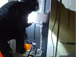 Supporting image for story: Watch as police chainsaw down door to unearth huge haul of drugs on residential street in Dudley