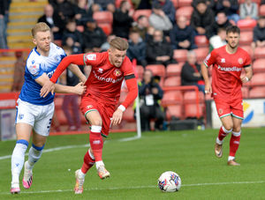 Tom Knowles drives forward with the ball