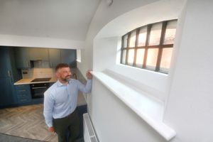 Liam Floyd takes a peek through the cell window