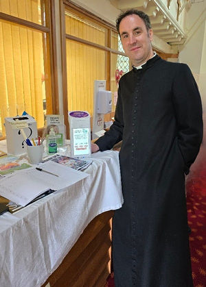 Father Stuart Howes with the payment terminal at Hadley Holy Trinity