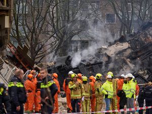 Supporting image for story: Rescuers search for victims after apartment block blast
