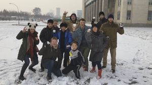 Mr Gratton, crouched down at the back, and Mr Warmbier, fourth from the right, in North Korean snow
