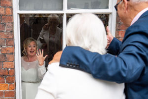 Tracie Kenny shows her wedding ring to her parents, who had to watch her marriage from outside 