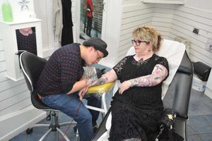 Sue McElhone being worked on by artist Stacie Coyne