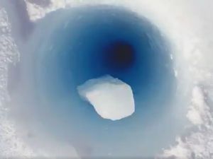 Supporting image for story: This captivating video of ice dropping down a 90-metre hole needs to be watched with the sound on