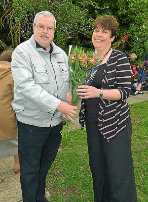 Gyorgy Buslig hands flowers to headteacher Val Matthews