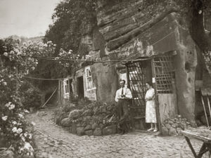 An evocative image of the Kinver Edge rock houses when they were still used as homes. Pictured are Sid and Liz Reeves pictured outside their home, which boasted a pretty garden with climbing roses. The homes can still be explored under the care of the National Trust charity.
