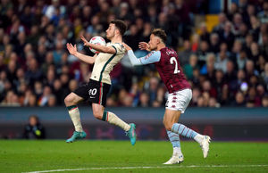 Liverpool's Diogo Jota controls the ball in the air as he is challenged by Aston Villa's Matty Cash
