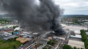 Black smoke pours into the sky from the fire at GB Tyres in West Bromwich. Photo: Tim Thursfield