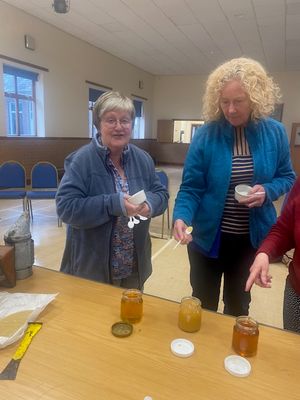 Bernie and Debra enjoying trying the honey