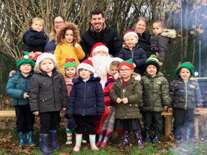 Supporting image for story: Santa gets a warm welcome at nursery with camp fire 