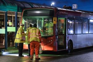 Police and National Express workers examine a bus after a man was hit in Dudley town centre. Image: SnapperSK