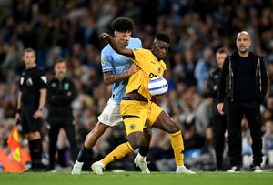 Marshall Munetsi of Wolverhampton Wanderers is challenged by Nico O'Reilly  (Photo by Stu Forster/Getty Images)