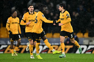 Wolverhampton Wanderers' Spanish defender #03 Hugo Bueno (R) celebrates scoring the team's first goal during the English Premier League football match between Wolverhampton Wanderers and Arsenal at the Molineux stadium in Wolverhampton, central England on February 18, 2026. (Photo by Paul ELLIS / AFP via Getty Images) / RESTRICTED TO EDITORIAL USE. No use with unauthorized audio, video, data, fixture lists, club/league logos or 'live' services. Online in-match use limited to 120 images. An additional 40 images may be used in extra time. No video emulation. Social media in-match use limited to 120 images. An additional 40 images may be used in extra time. No use in betting publications, games or single club/league/player publications. / 