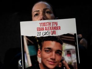 Yael Alexander holds a poster of her son, Edan, who was taken hostage by Hamas militants on October 7 2023
