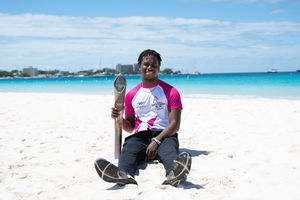 Batonbearer Ryan Archer gives the baton a break on the beach in Barbados