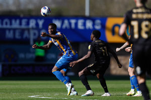 Chey Dunkley of Shrewsbury Town and Kwame Poku of Peterborough United.