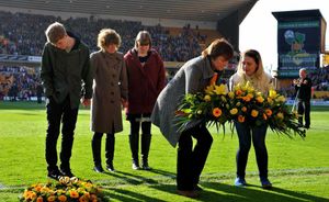 Sharon Matthews lays a wreath for her husband, Martyn