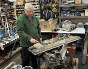 National Motor Museum Senior Engineer Ian Stanfield shows sump repair patch on Sunbeam 1000hp front engine