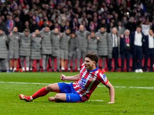 Atletico Madrid’s Julian Alvarez falls to the ground after taking a penalty during a shootout at the end of the Champions League round of 16, second leg match against Real Madrid