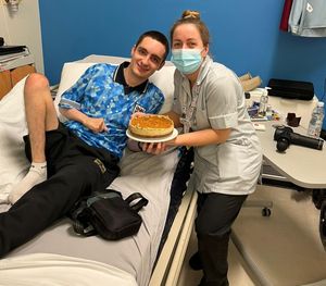 Jude Aston with a cake Georgie Varty helped him make