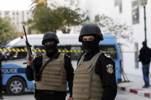 Police officers guard the entrance of the National Bardo Museum after gunmen opened fire killing scores of people